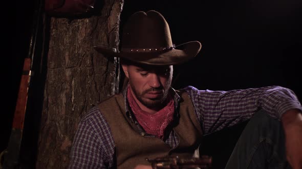 Cowboy with a Gun in the Forest at Night