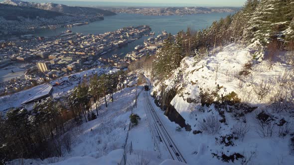 Still shot railroad Fløybanen funicular coming up the hills to mount Fløyen - winter scene Bergen ci