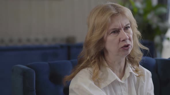 Close-up Portrait of Confident Senior Caucasian Woman Talking To Unknown Interlocutor