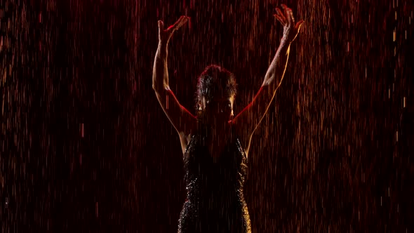 Burning Brunette Passionately Dancing Flamenco in the Rain. Graceful Hand Movements in Slow Motion