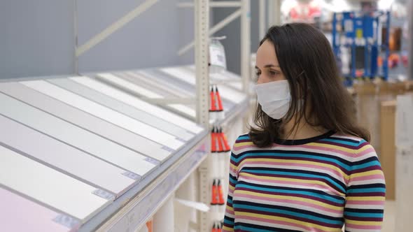 Young Woman in Store Choosing Wallpaper for Home