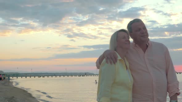 Loving Mature Couple Having a Walk on the Beach