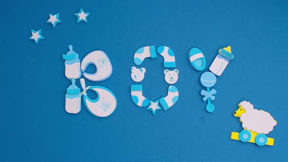 Funny Blue Stickers Symbolizing a Newborn Boy Appear on a Blue Background