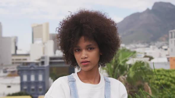 Front view of mixed race woman on rooftop