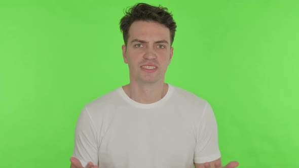 Angry Young Man Abusing on Green Background