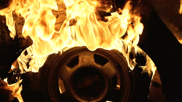 A Wheel Burns in a Car at Night, Car Tires Burn
