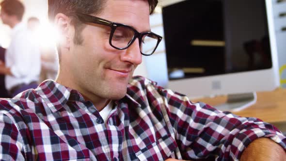 Smiling businessman using his smart watch