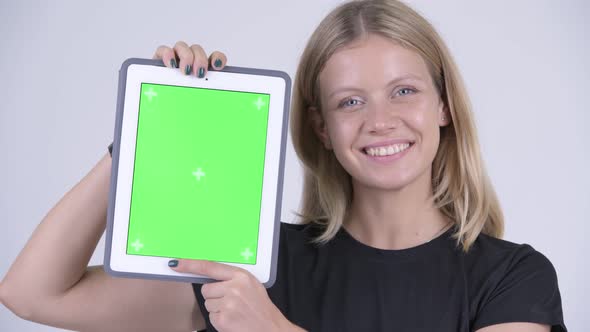 Face of Young Happy Blonde Woman Showing Digital Tablet