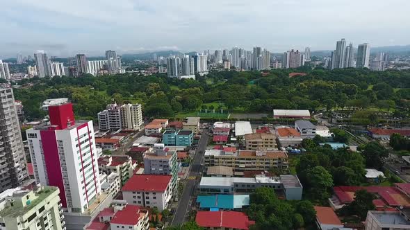 Aerial drone footage of modern buildings behind the park  in Panama City with camera panning