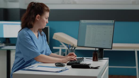 Nurse Typing on Computer Keyboard for Consultation