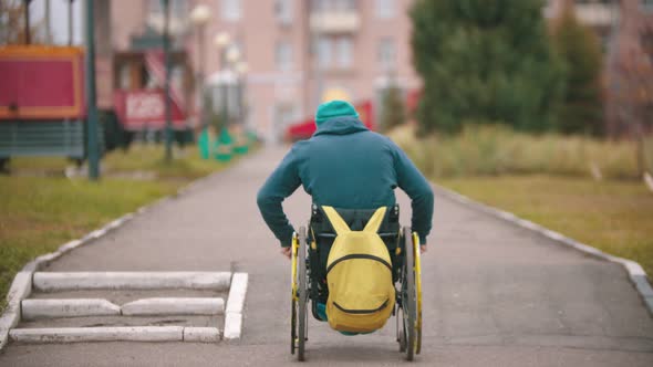 Disabled Man in Wheelchair Getting Up Over a Ramp