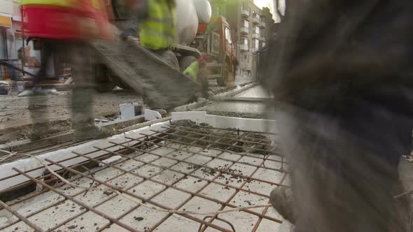 Pouring Readymixed Concrete After Placing Steel Reinforcement to Make the Road By Concrete Mixer