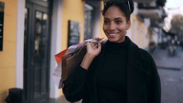 Portrait of an Attractive Mixed Race Girl Smiling While Walking Down the Street with Colorful