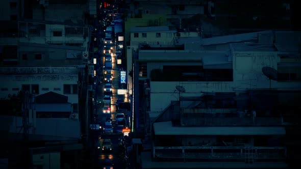 Cars Light Up Avenue At Dusk In City