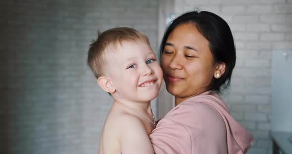 Multinational mom and child, mixed-race family of parent and son happy together