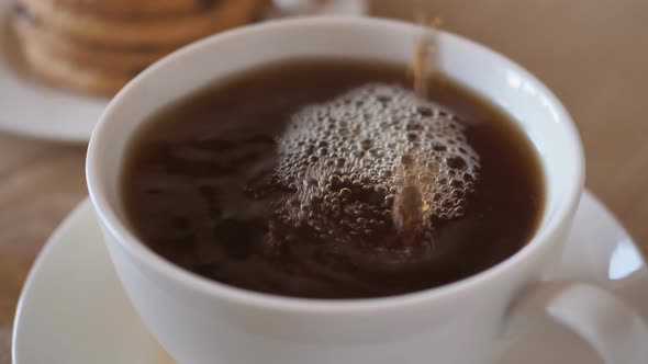 Pouring Black Coffee Into the Cup