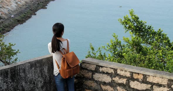 Woman go hiking and taking photo of the sea view