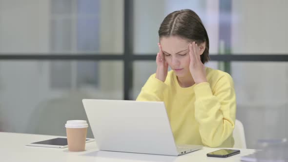 Young Woman Having Headache While Working on Laptop