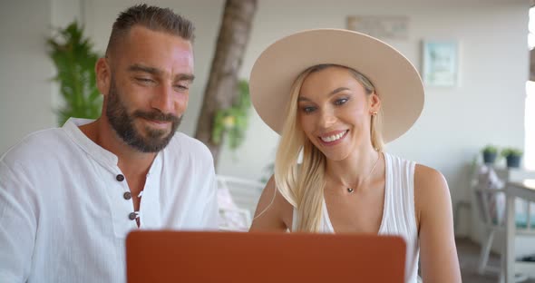 Two Young People are on Holiday in Southern Country Having Video Conference with Their Relatives