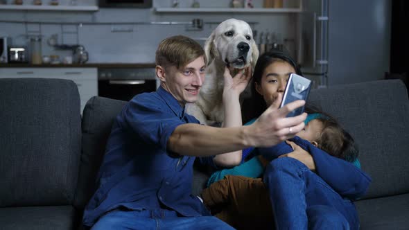 Multi Ethnic Family with Pet Dog Posing for Selfie