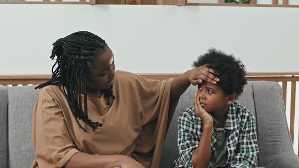 Mother Calming down Son with Tooth Pain