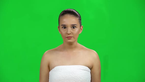 Girl in White Towel Is Angry and Gesturing with Her Hands, Covering Her Ears with Her Hands