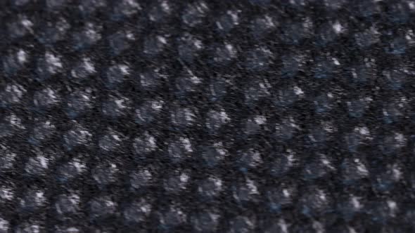 Black absorbent cloth, macro shot close up view with fast rotation motion.