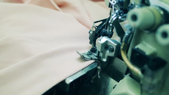 Clothing Material is Getting Processed with a Sewing Machine