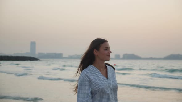 Close Up View of Attractive Young Brunette Woman Walking on the Beach in Dubai