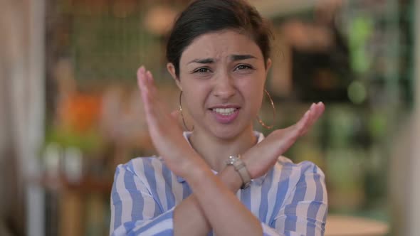 Cheerful Young Latin Woman Waving at the Camera