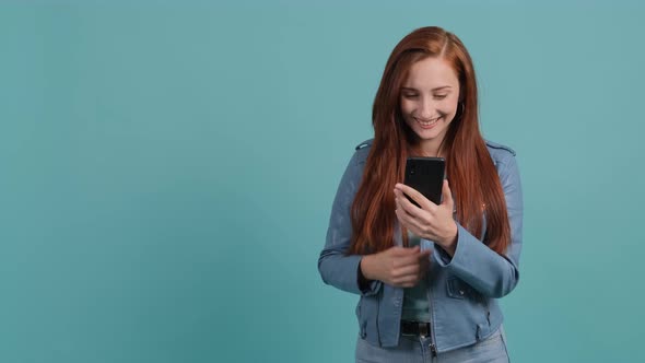 Young Woman Watching a Funny Video on Smartphone