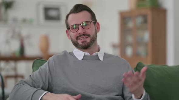 Middle Aged Man Doing Video Call While Sitting on Sofa