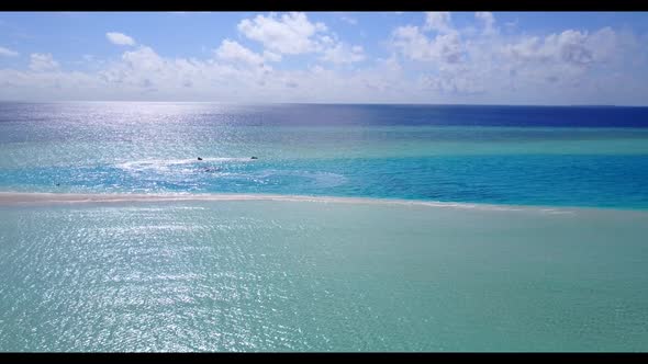 Aerial above scenery of idyllic shore beach time by aqua blue ocean with white sandy background of a