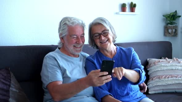 close up of two seniors or old mature people doing a video call with friends or parents