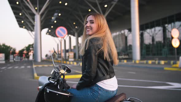 Young Stylish Woman Wearing Leather Jacket Woman on Vintage Scooter on Urban Background