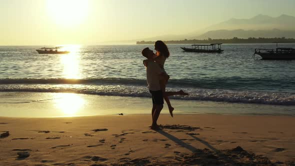 Family of two happy together on perfect tourist beach trip by blue green lagoon with white sand back