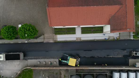 Maintenance, repair of roads. Laying of new asphalt pavement by heavy equipment