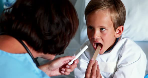 Female doctor examining patient mouth