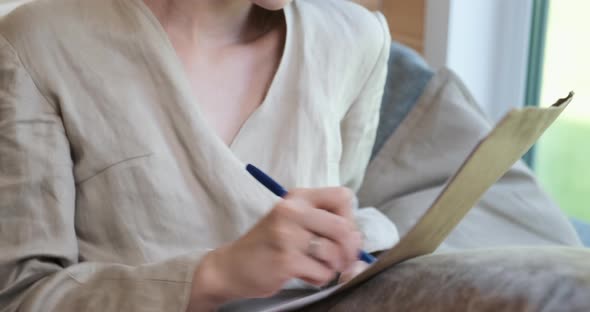 Young Woman Writes Thought in Her Diary and Angry Strikethrough Them