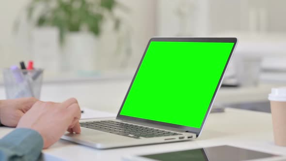 Middle Aged Man using Laptop with Chroma Screen