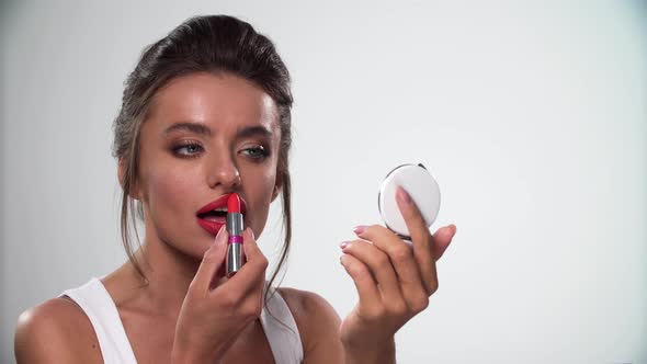 Lips Makeup. Beautiful Woman Applying Red Lipstick On Lip