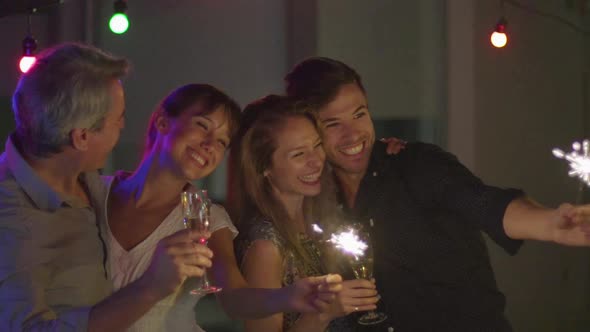 Friends celebrating with wine and sparklers