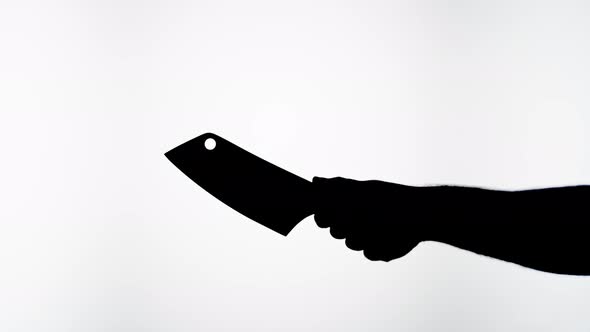 Man Holding Knife Axe Closeup Shadow Silhouette of Hand with Weapon on White Background