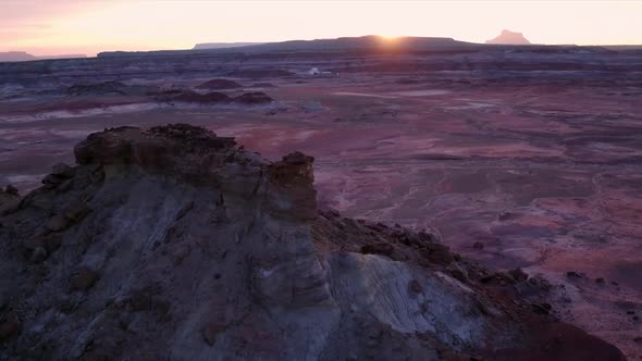 Colorful sunset over Mars type terrain flying towards the ground