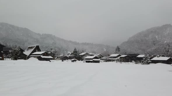 Snow Fall At Village In Valley