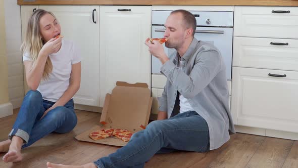 Couple Enjoying Eating Pizza at Home.