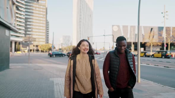 Diverse Friends Chatting During Stroll in City