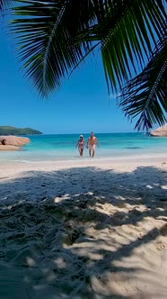Anse Source d'Argent La Digue Seychelles Young Couple Men and Woman on a Tropical Beach During a