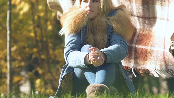 Guy Wrapping Girlfriend With Blanket in Park, Cold Autumn Day, Caring Relations