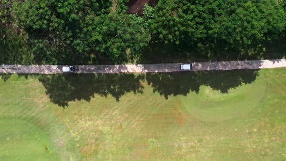 4K Aerial view group of Asian people golfing on at golf course in summer sunny day.